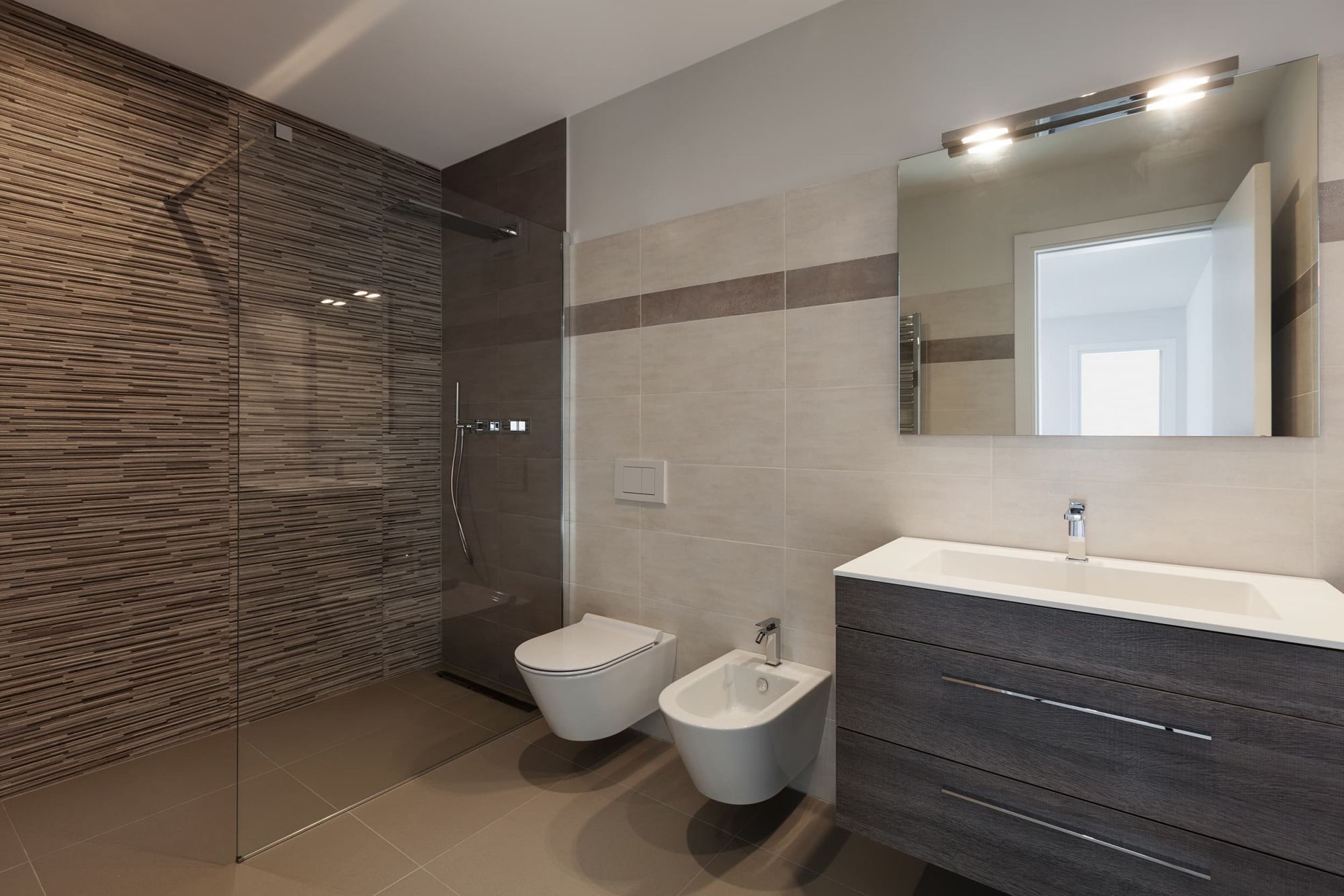 Badezimmer mit verschiedenen, braunen Fliesen